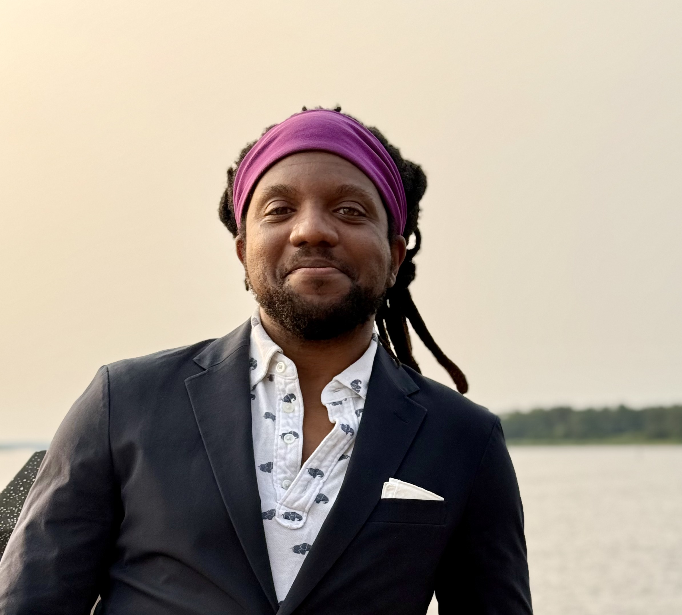 Thomas Edwards in a navy blazer by the waterfront